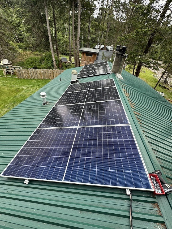 Solar panels installed on a green metal roof