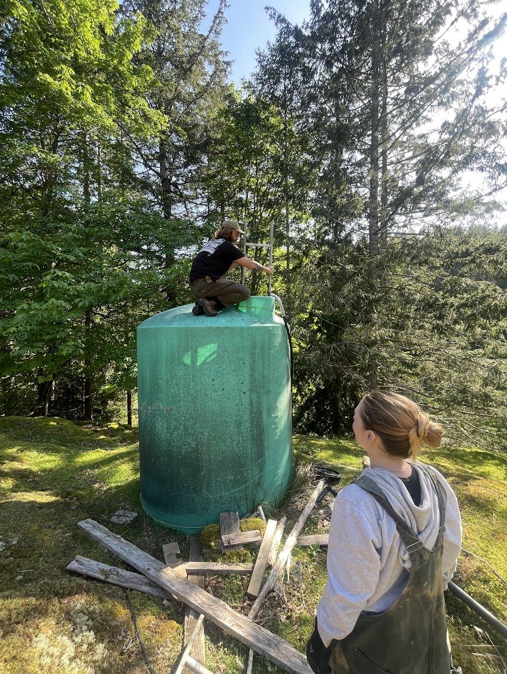 Working on a large water tank in the forest
